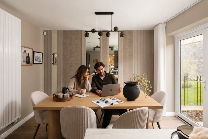 Young couple sat round table